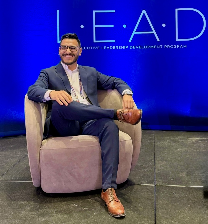 Eddie seated on stage at the AdventHealth L·E·A·D Executive Leadership Development Program.